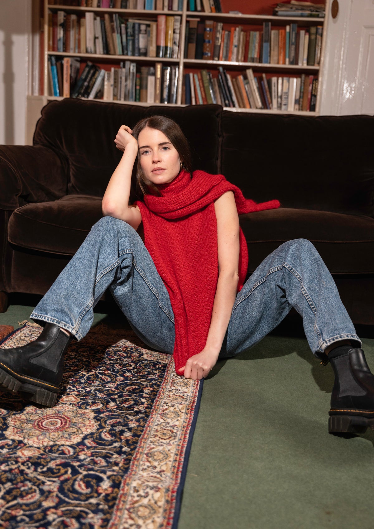 Woman sitting on floor wearing red scarf